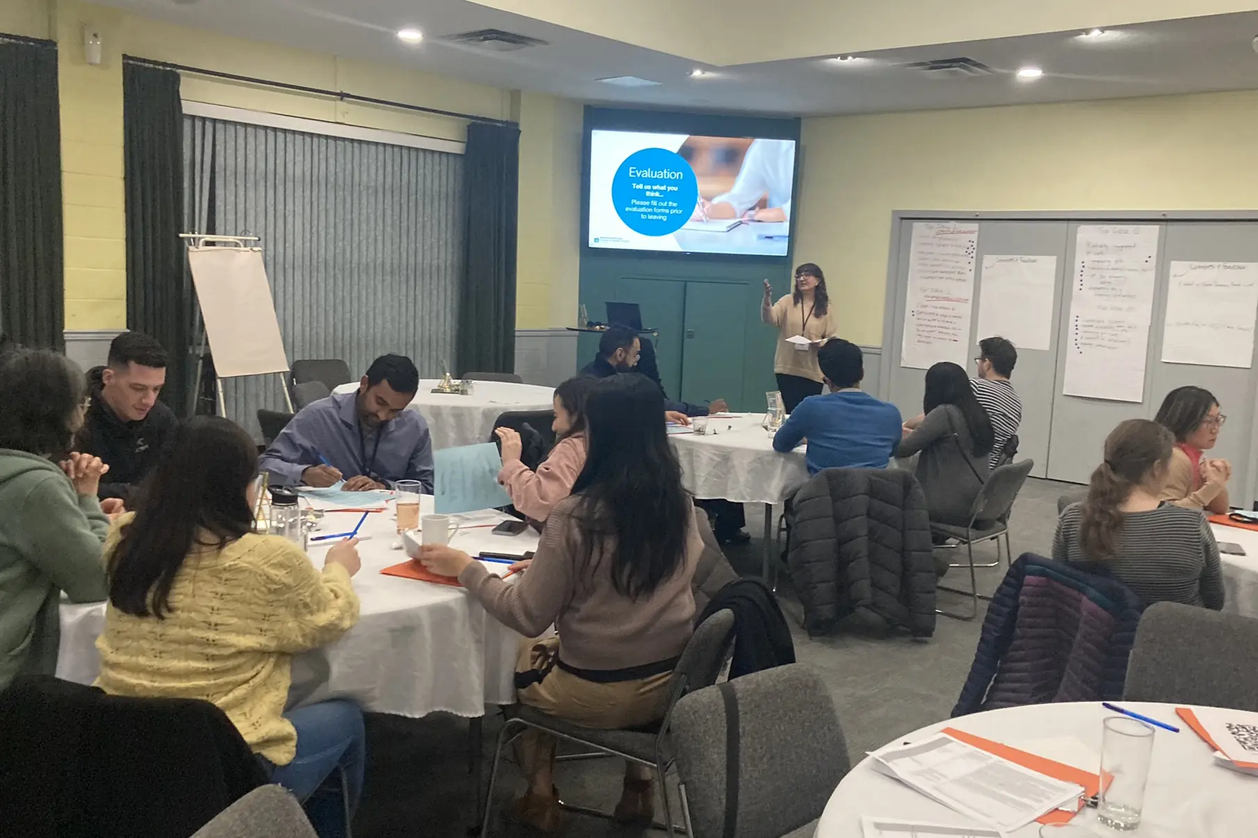 Physicians attending a meeting with a presenter at the front, held in White Rock, South Surrey.